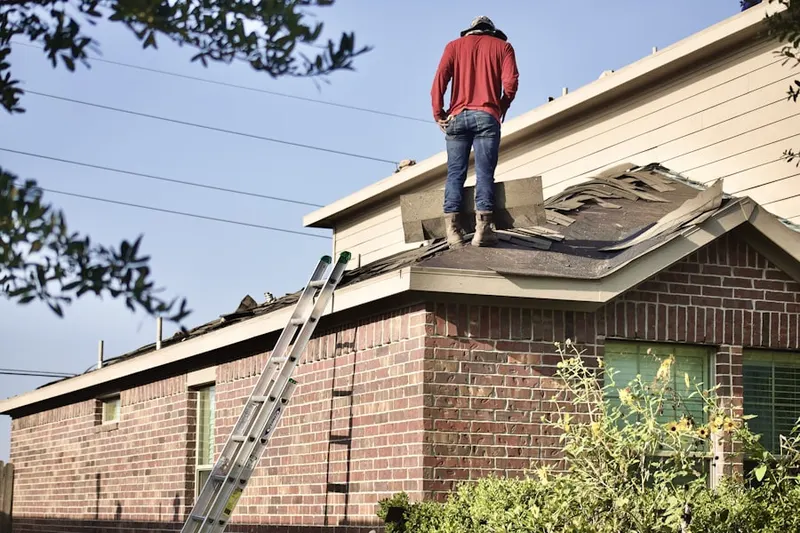 Professional roofer working on a residential roof in Arrowhead Village